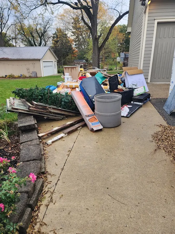 Dumpster being loaded with debris for Estate Cleanout Dumpster Rental in Ridgway